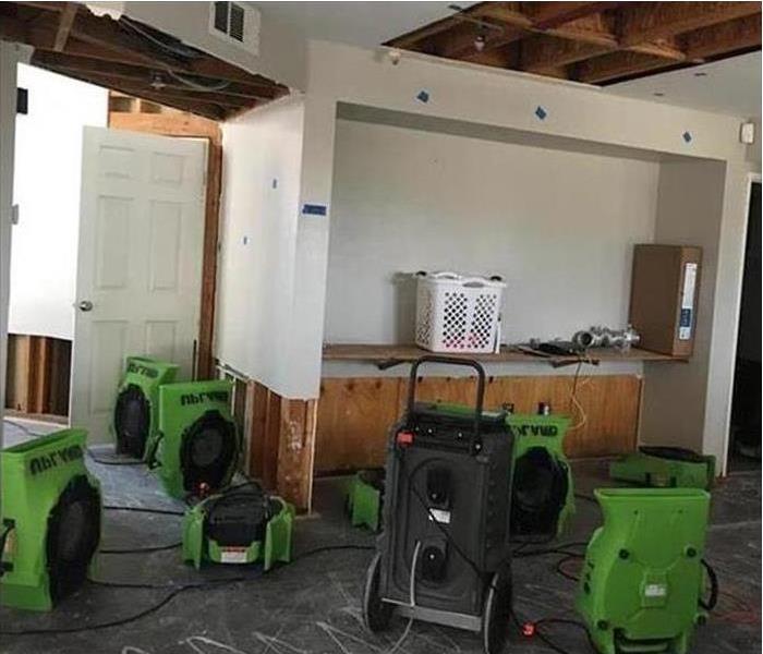 eight air movers in a room to mitigate water damage