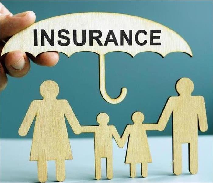 insurance umbrella with cutouts of a family
